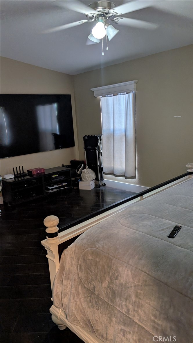 3424 West Washington Avenue, Unit 228 Santa Ana, CA 92703 - Photo 22 of 31 a bedroom with a bed and a flat screen tv