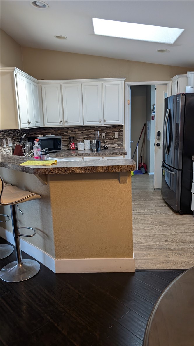 3424 West Washington Avenue, Unit 228 Santa Ana, CA 92703 - Photo 6 of 31 a view of a kitchen with wooden floor and stainless steel appliances