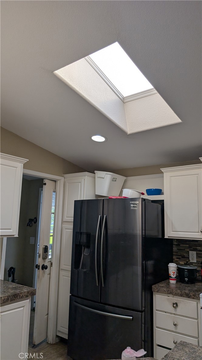 3424 West Washington Avenue, Unit 228 Santa Ana, CA 92703 - Photo 9 of 31 a metallic refrigerator freezer sitting in a kitchen
