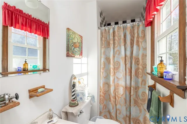 a view of a bedroom with furniture and a window
