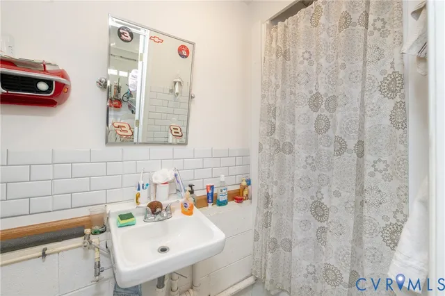 a bathroom with a sink and a shower curtain