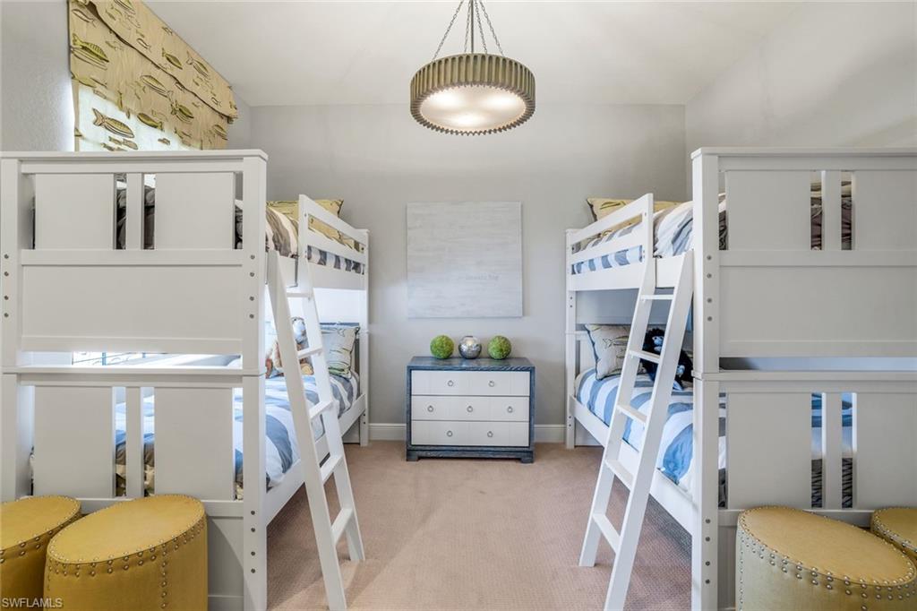 9053 Cascada Way, Unit 202 Naples, FL 34114 - Photo 17 of 45 a bedroom with furniture and a gym equipment