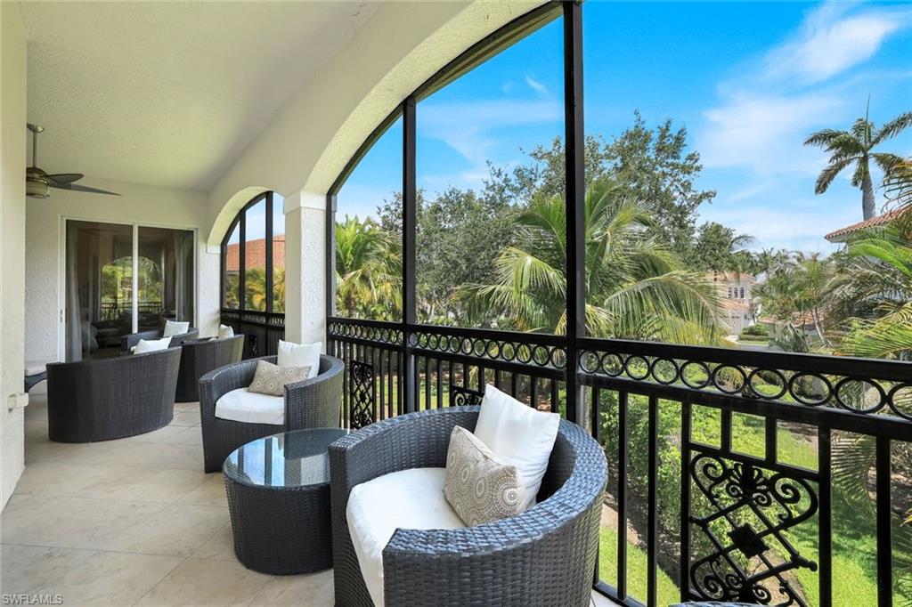 9053 Cascada Way, Unit 202 Naples, FL 34114 - Photo 24 of 45 a balcony with furniture and a potted plant