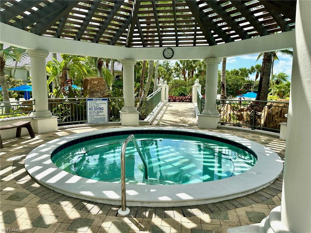 9053 Cascada Way, Unit 202 Naples, FL 34114 - Photo 31 of 45 a view of a swimming pool with a patio
