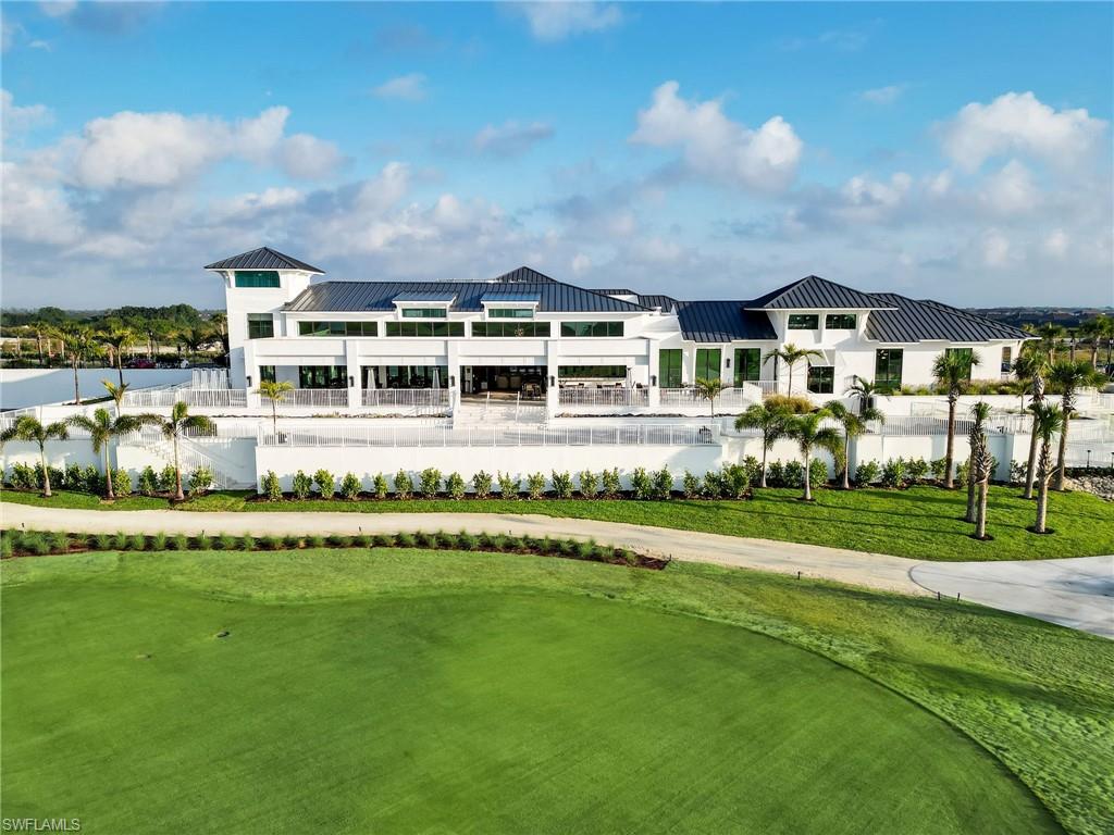 9053 Cascada Way, Unit 202 Naples, FL 34114 - Photo 37 of 45 a front view of residential houses with yard and green space