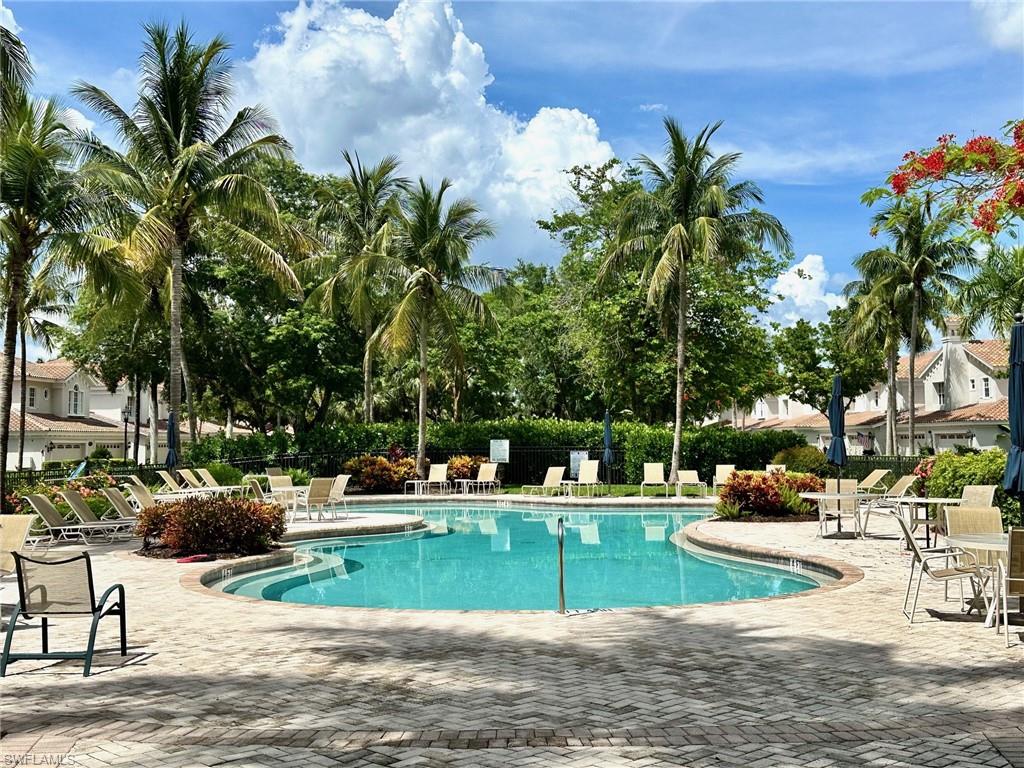 9053 Cascada Way, Unit 202 Naples, FL 34114 - Photo 43 of 45 a view of a swimming pool with a patio