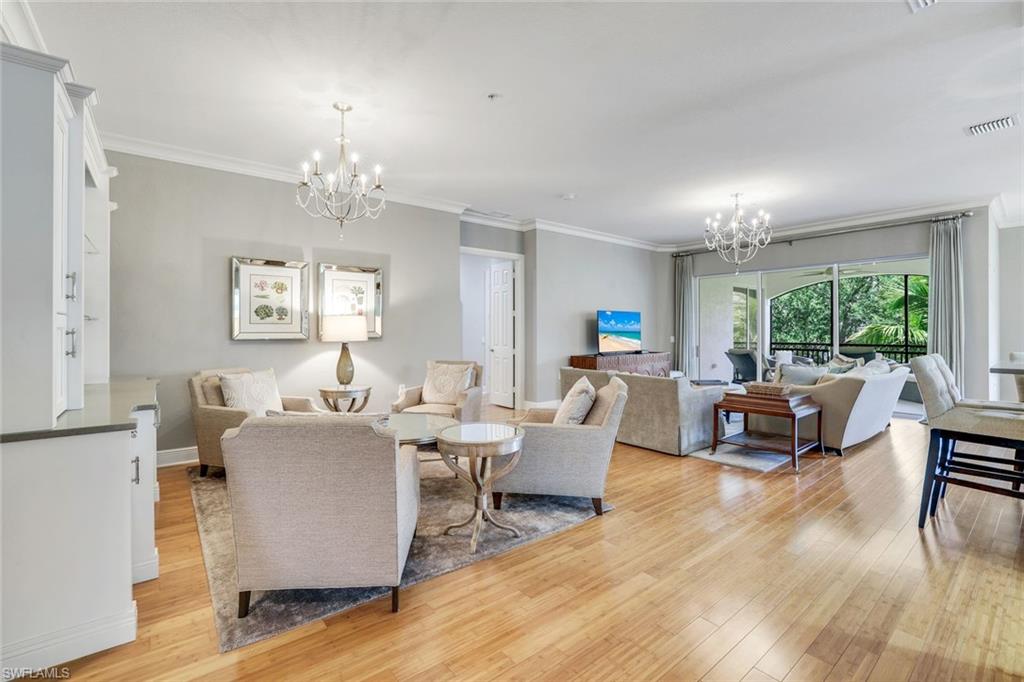 9053 Cascada Way, Unit 202 Naples, FL 34114 - Photo 8 of 45 a living room with fireplace furniture and a wooden floor