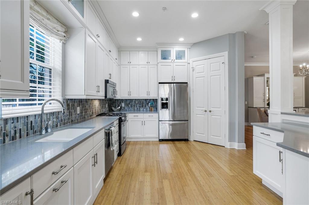9053 Cascada Way, Unit 202 Naples, FL 34114 - Photo 10 of 45 a kitchen with stainless steel appliances a refrigerator sink and cabinets