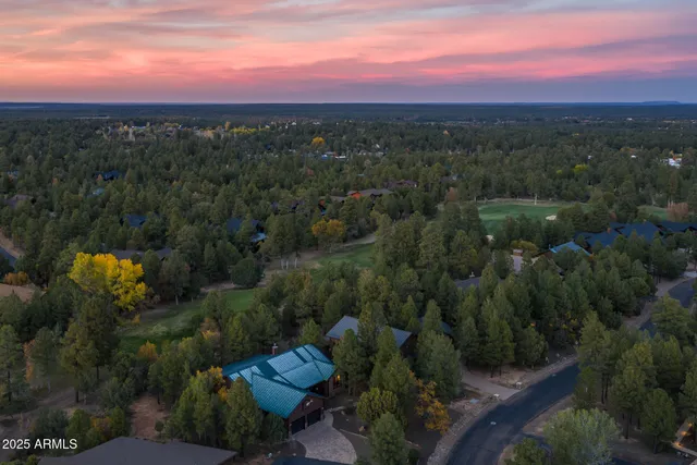 an aerial view of a house with a yard basket ball court and outdoor seating