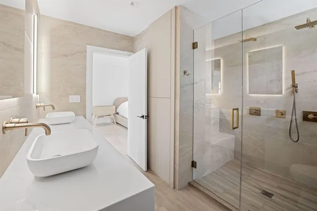 a spacious bathroom with a shower and a sink