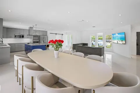 a living room with furniture and a kitchen