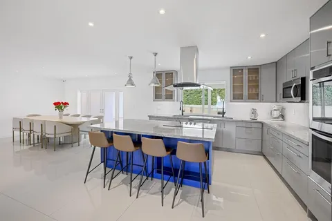 a large kitchen with a table and chairs