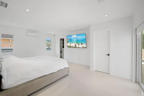 a room with a bed and a painting on the wall