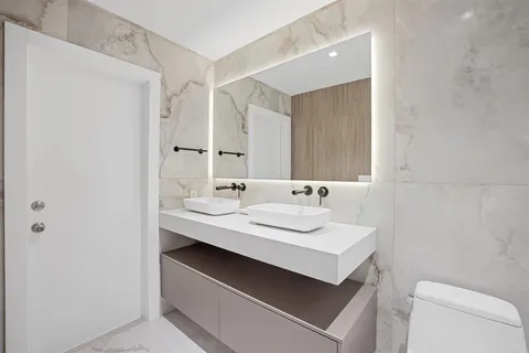 a bathroom with a sink toilet a mirror and vanity
