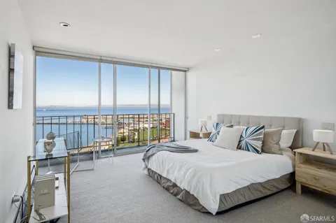 a bedroom with a bed and a night stand