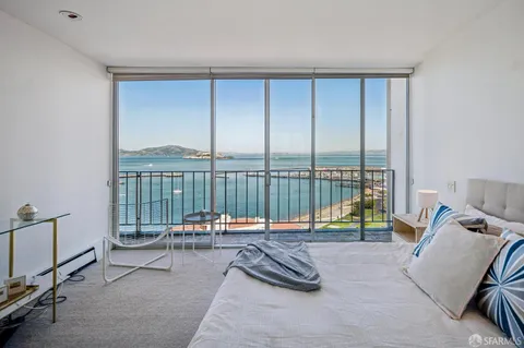 a living room with furniture and floor to ceiling window