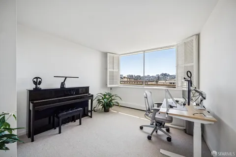 a view of a workspace with furniture and a kitchen
