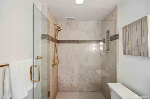 a bathroom with a shower and a toilet