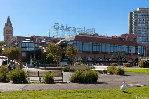 a front view of a building with outdoor seating