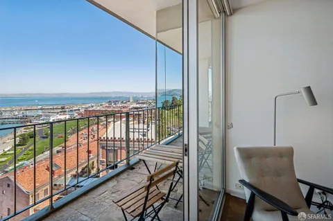 a view of a balcony with furniture and staircase