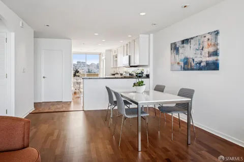 a view of a dining room with furniture and wooden floor