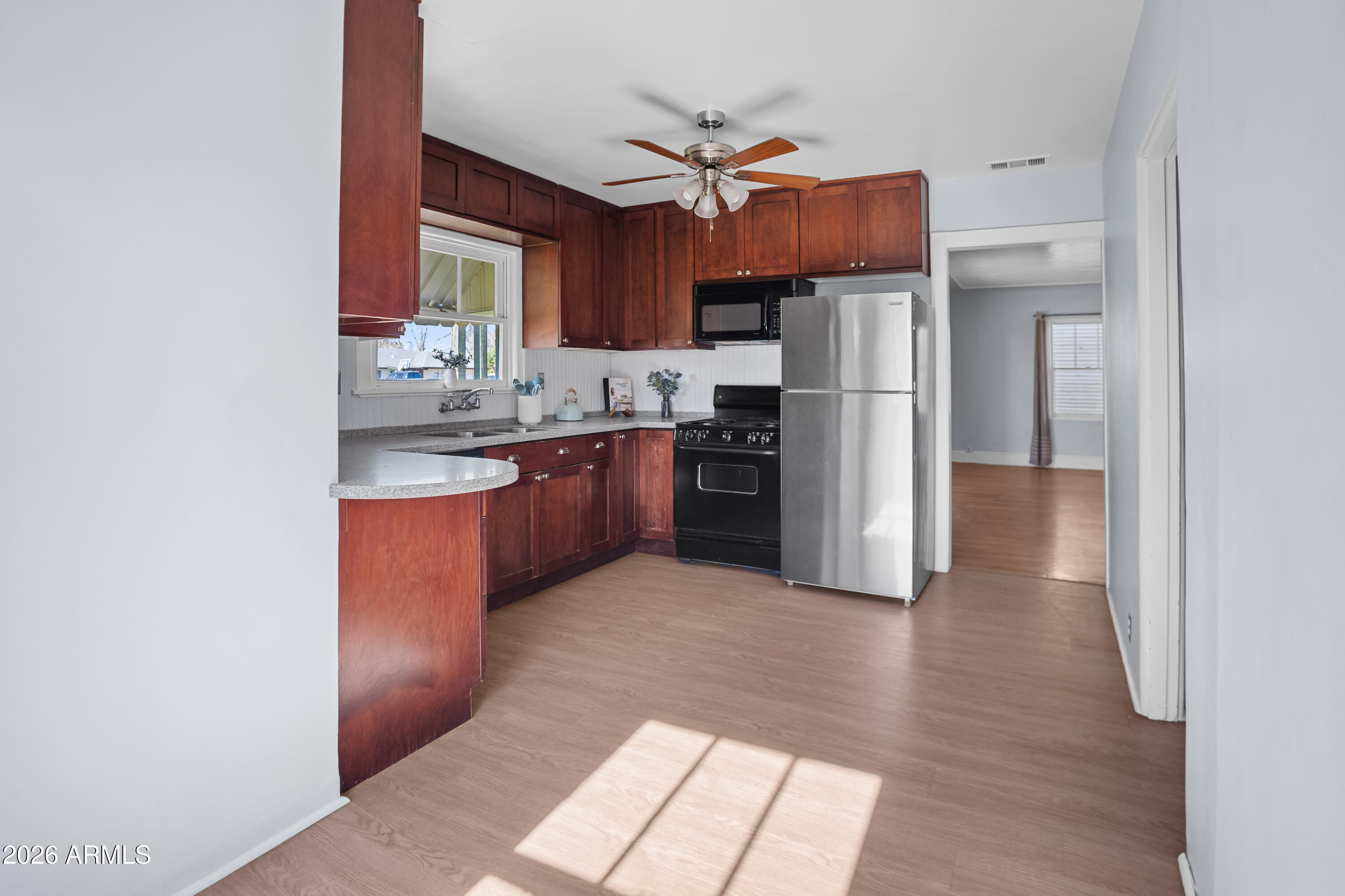 505 North Robson Mesa, AZ 85201 - Photo 7 of 27 a kitchen with stainless steel appliances granite countertop a stove a refrigerator and a sink