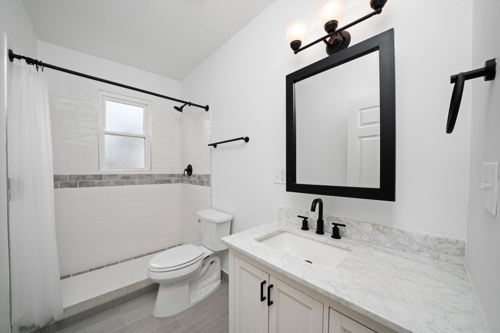 1134 West 104th Street Chicago, IL 60643 - Photo 25 of 53 a bathroom with a toilet a sink and mirror