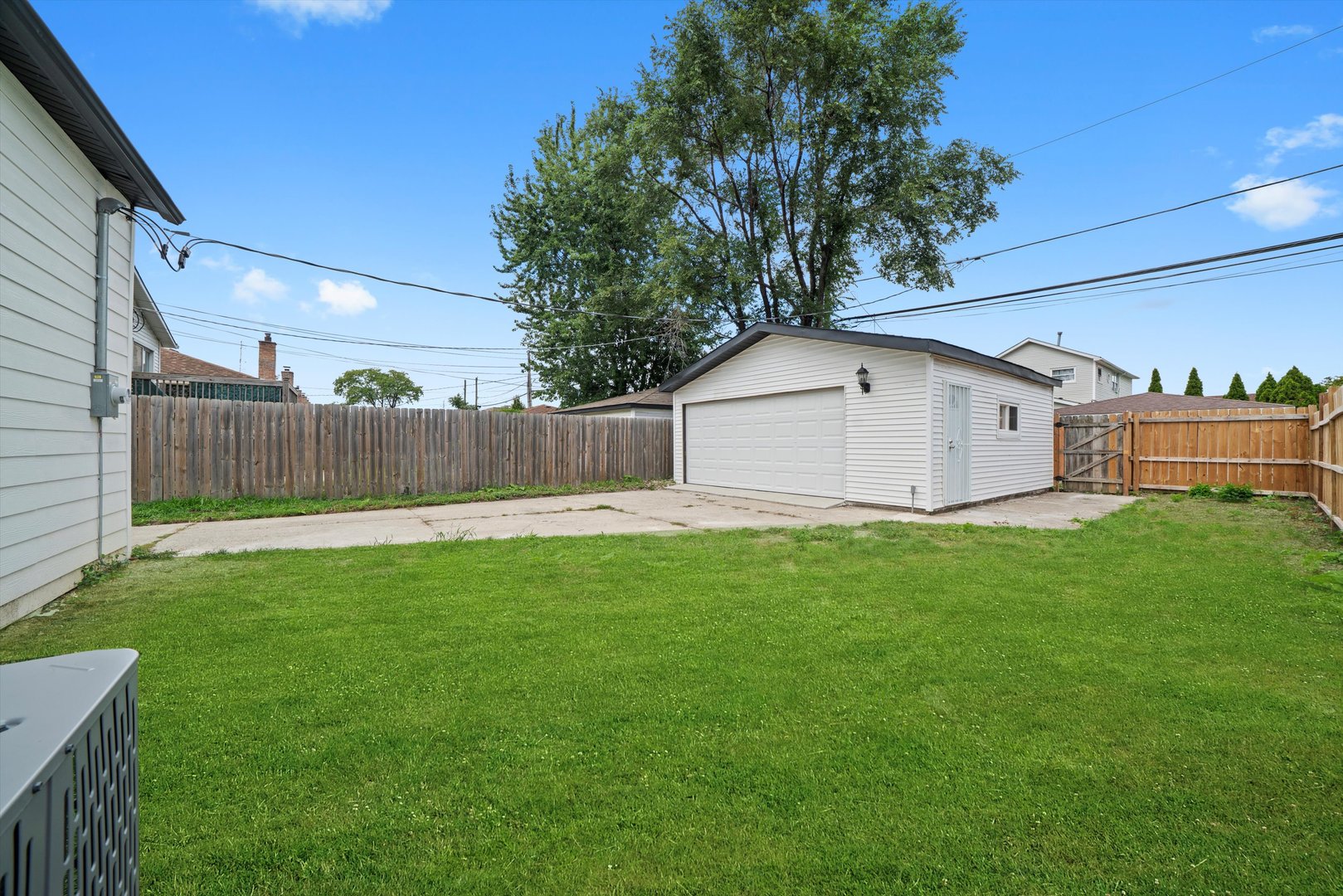 1134 West 104th Street Chicago, IL 60643 - Photo 4 of 53 a view of a white house in front of a yard with wooden fence