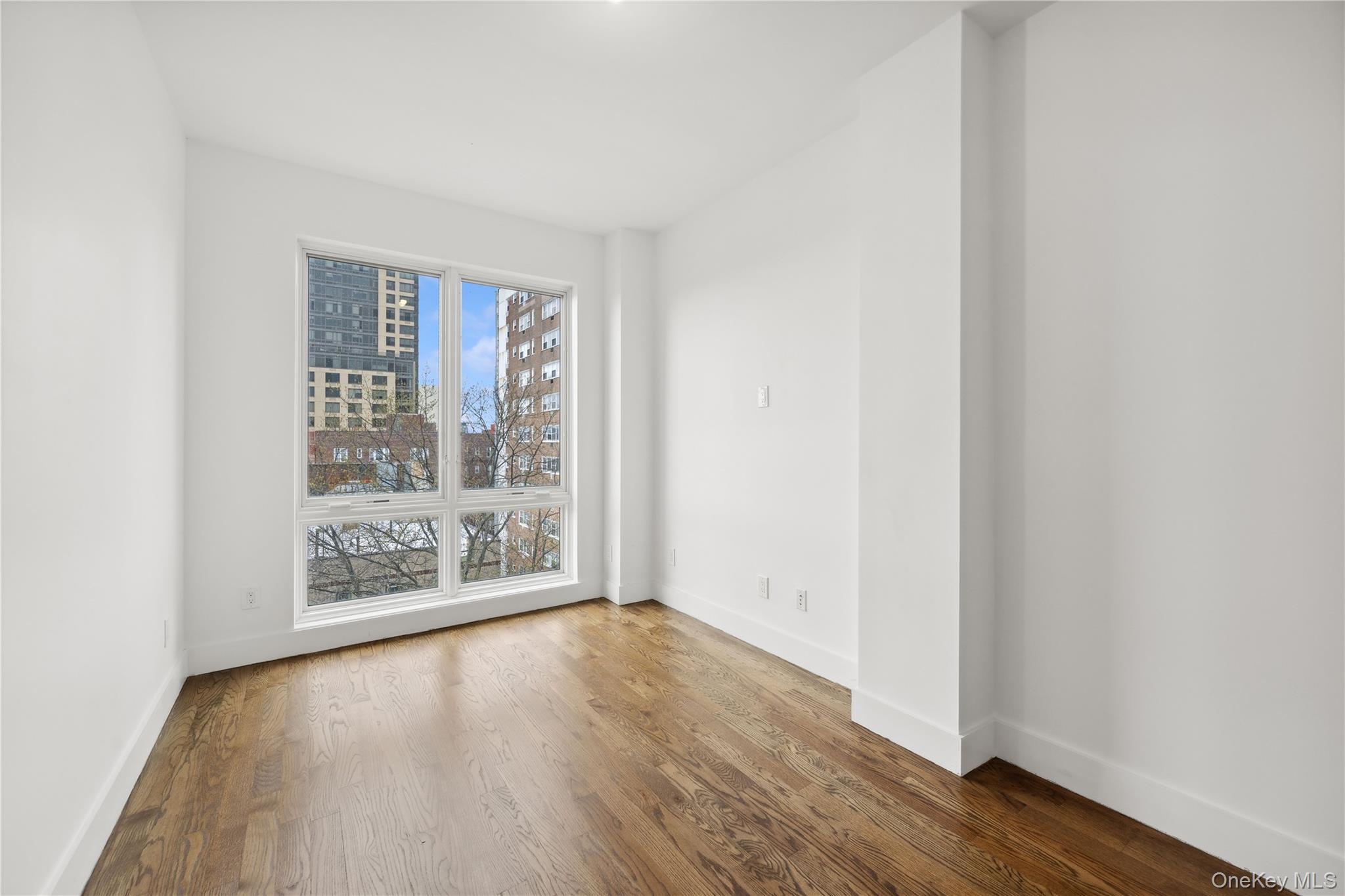 109-19 72nd Road, Unit PH7F Queens, NY 11375 - Photo 10 of 27 an empty room with wooden floor and windows