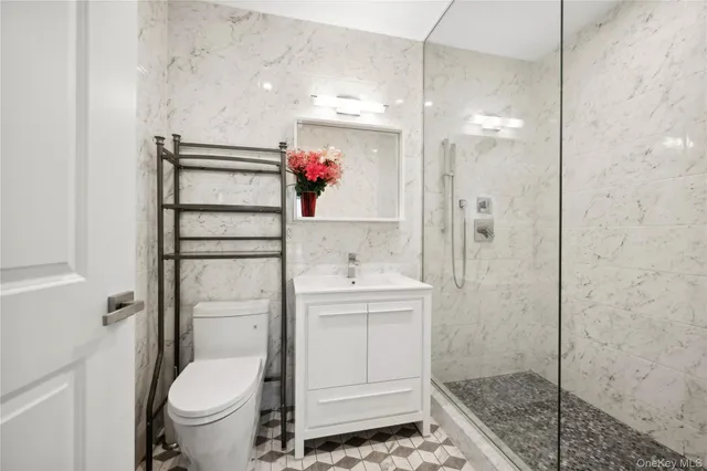 a bathroom with a shower toilet and sink
