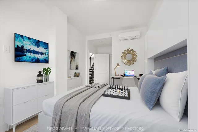 a bedroom with a large bed and a chandelier