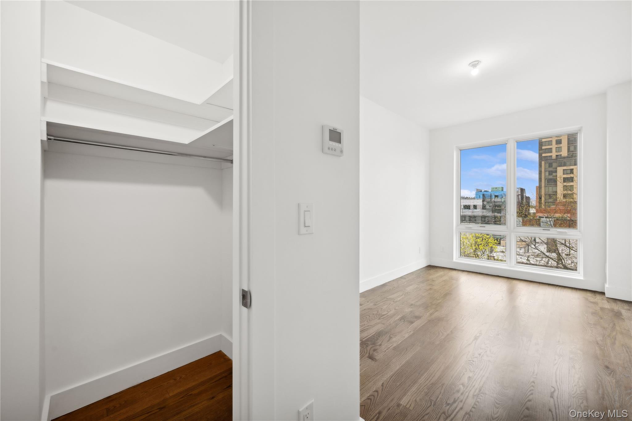 109-19 72nd Road, Unit PH7F Queens, NY 11375 - Photo 14 of 27 a view of an empty room with wooden floor and a window