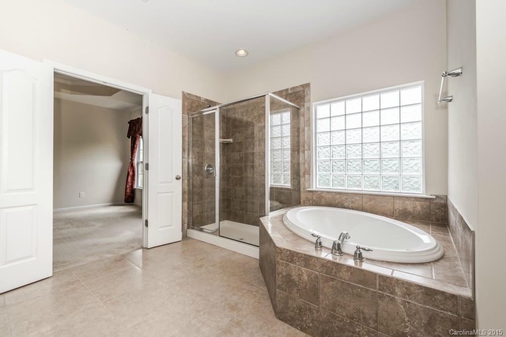 312 Miners Cove Way Fort Mill, SC 29708 - Photo 17 of 24 a bathroom with bathtub and shower