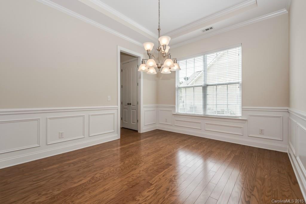 312 Miners Cove Way Fort Mill, SC 29708 - Photo 5 of 24 an empty room with wooden floor and windows