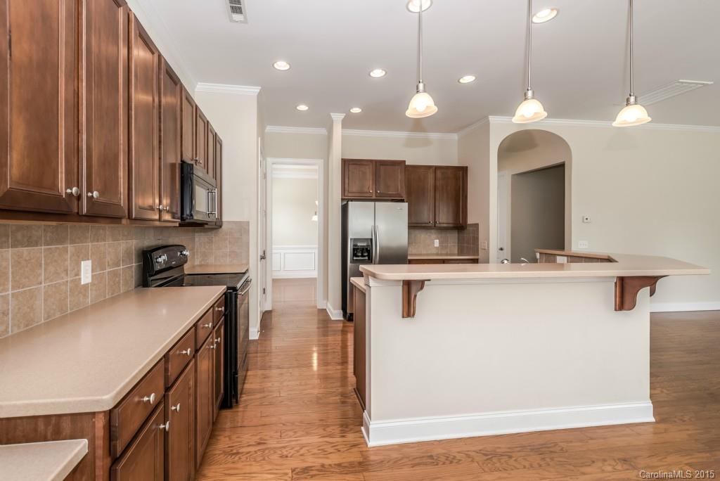 312 Miners Cove Way Fort Mill, SC 29708 - Photo 8 of 24 a kitchen with kitchen island a sink stainless steel appliances and cabinets