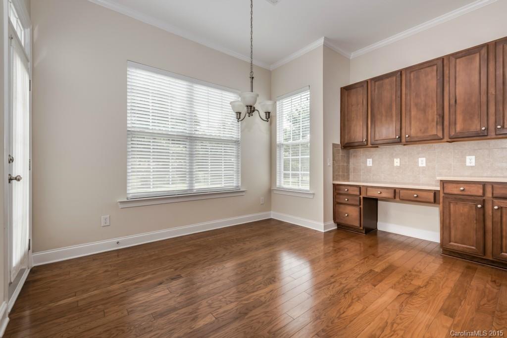312 Miners Cove Way Fort Mill, SC 29708 - Photo 9 of 24 a view of a kitchen with a stove wooden cabinets and a window