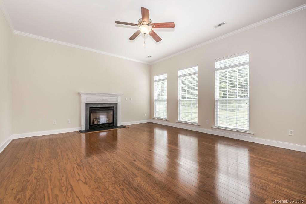 312 Miners Cove Way Fort Mill, SC 29708 - Photo 10 of 24 a view of an empty room with wooden floor and a window