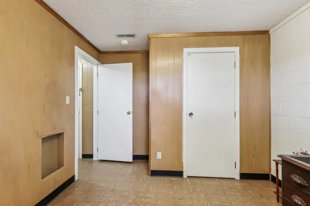 a view of a hallway with closet and wooden floor
