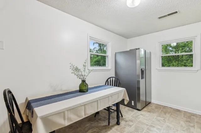 a kitchen with granite countertop white cabinets and white appliances