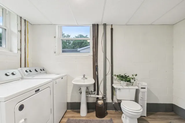 a view of bathroom with a toilet sink and a mirror