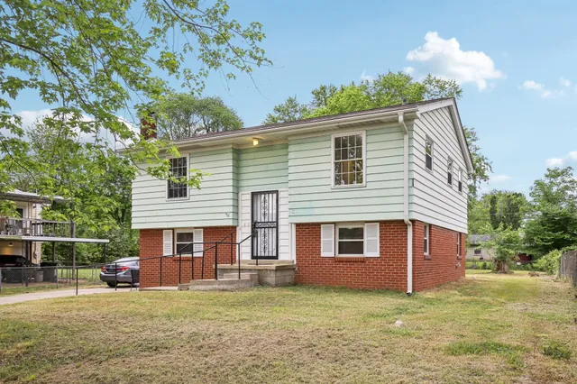 a front view of a house with a garden