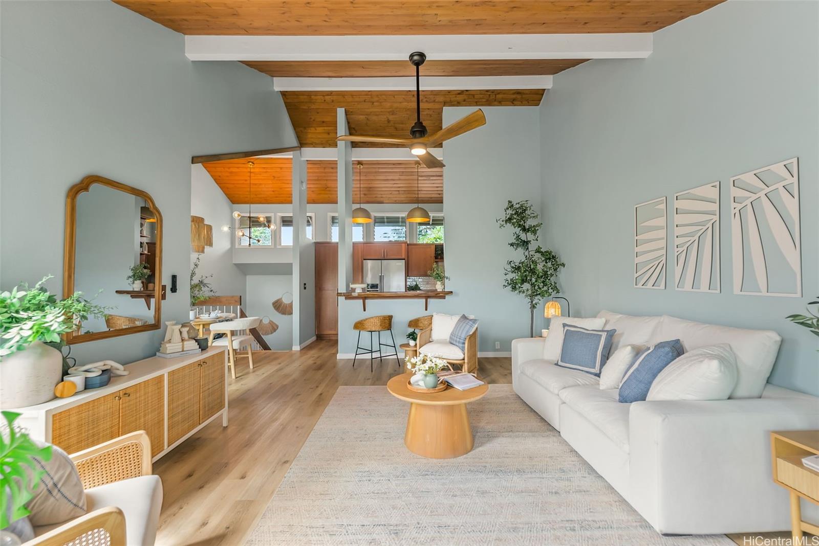 a living room with furniture and potted plants