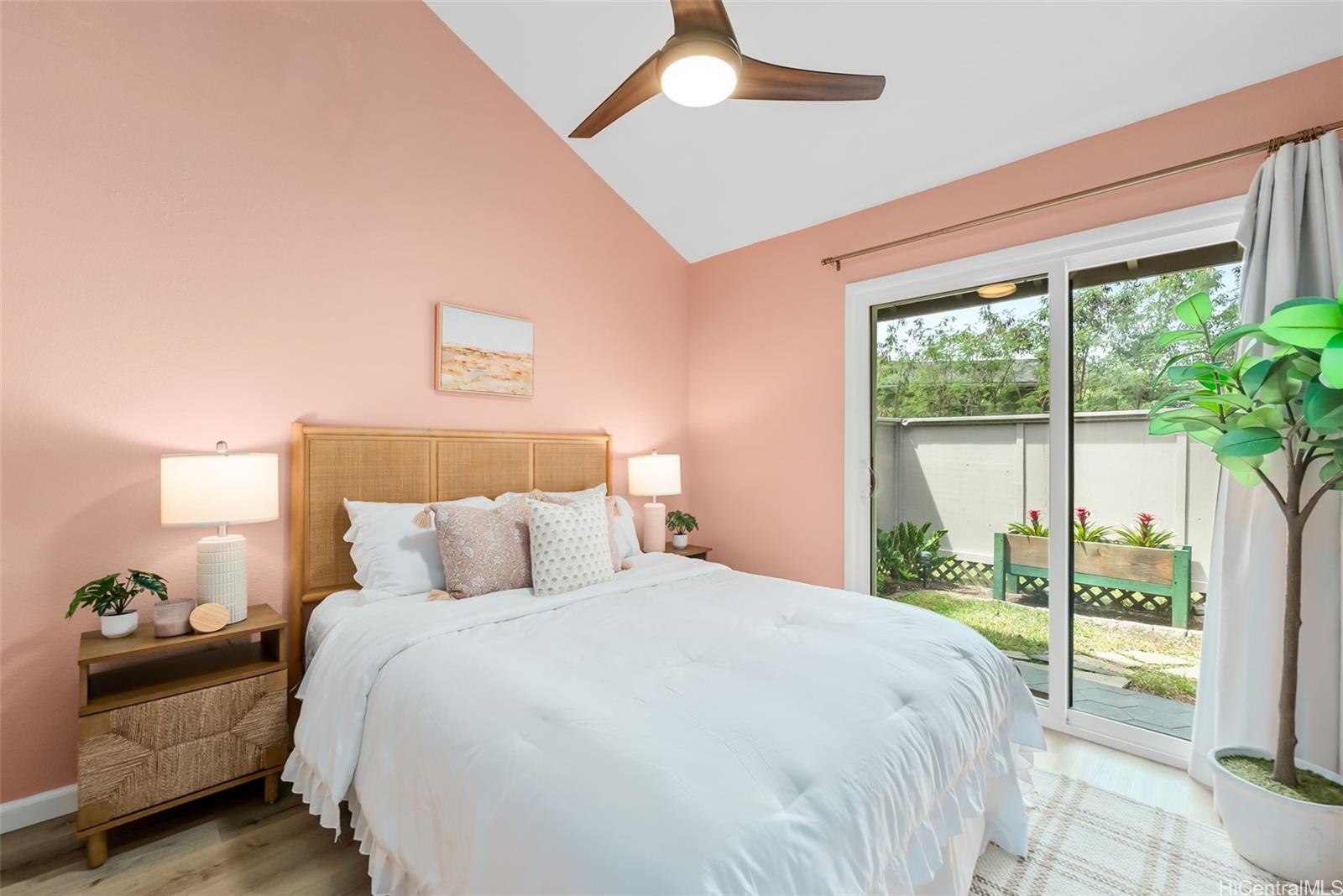 45-995 Wailele Road, Unit 55 Kaneohe, HI 96744 - Photo 14 of 24 a bedroom with a large bed and a large window