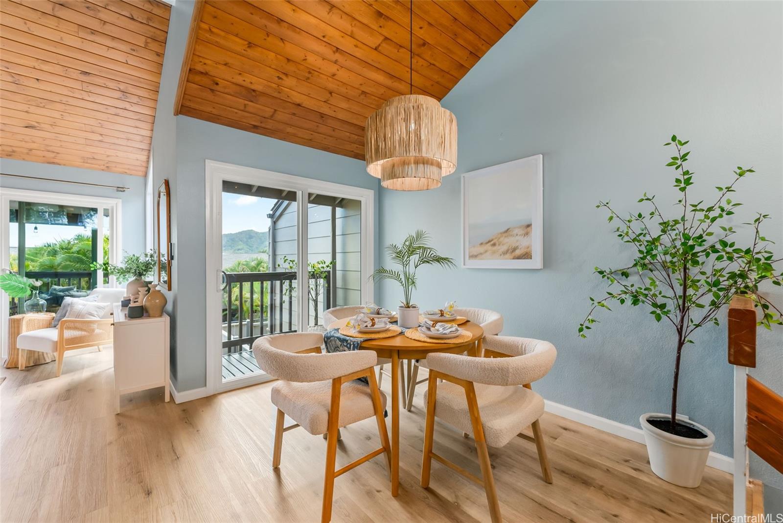 45-995 Wailele Road, Unit 55 Kaneohe, HI 96744 - Photo 4 of 24 a dining room with furniture wooden floor and a potted plant