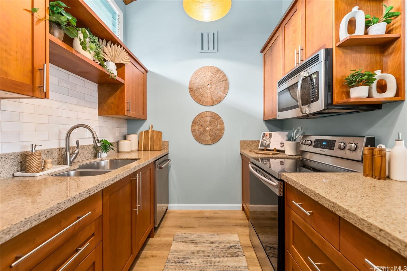 45-995 Wailele Road, Unit 55 Kaneohe, HI 96744 - Photo 5 of 24 a kitchen with stainless steel appliances granite countertop a sink and a stove