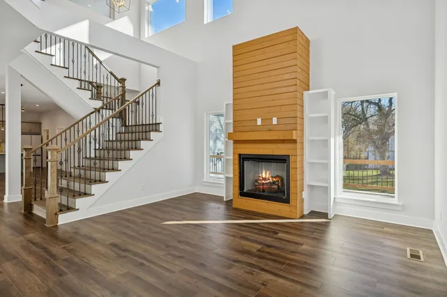 a view of an empty room with a fireplace and a window