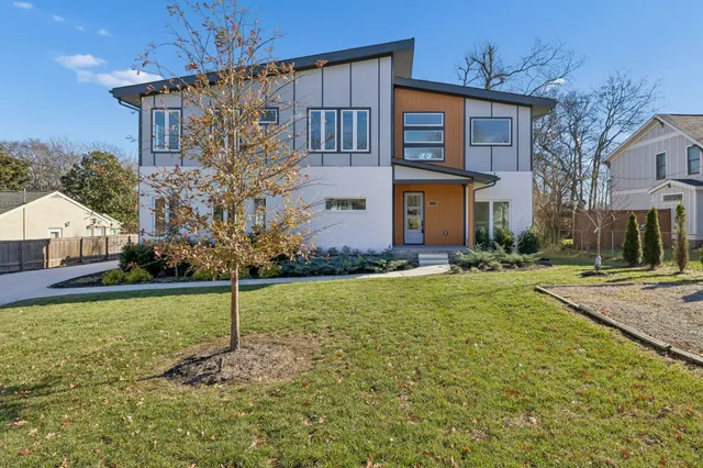 a kitchen with stainless steel appliances granite countertop a refrigerator a oven and a wooden floors