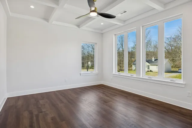 a kitchen with stainless steel appliances white cabinets and a wooden floor