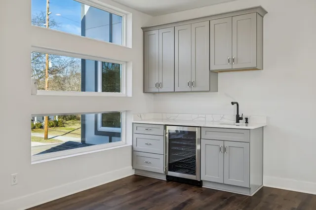 a view of a house with a big yard and large trees