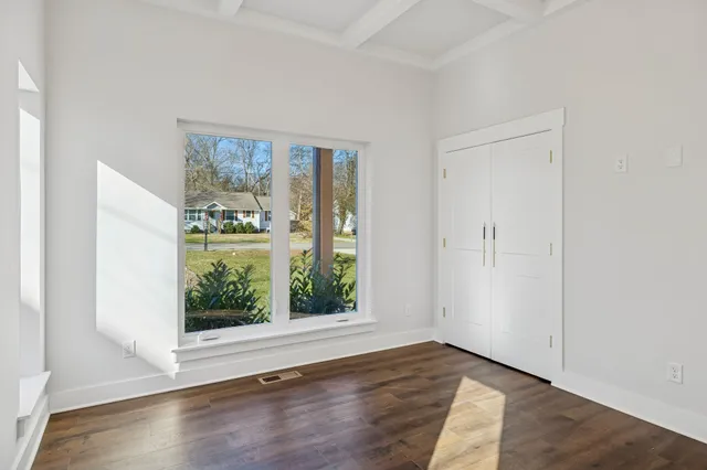 a bathroom with a granite countertop sink a toilet and a mirror
